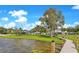 Picturesque backyard with a wooden dock, blending seamlessly into the natural lakefront landscape at 49 Interlaken Rd, Orlando, FL 32804