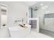 Bright bathroom featuring a soaking tub and walk-in shower at 49 Interlaken Rd, Orlando, FL 32804
