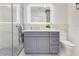 Bathroom with an illuminated mirror, gray vanity, and walk-in shower at 49 Interlaken Rd, Orlando, FL 32804