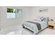 Bright bedroom featuring a bed, a large window with natural light, and modern decor, creating a serene and inviting atmosphere at 49 Interlaken Rd, Orlando, FL 32804