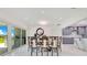 Bright dining area features a sleek table, modern chairs, and sliding glass doors to the backyard with lake views at 49 Interlaken Rd, Orlando, FL 32804