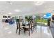 Spacious dining room with modern table setting, large windows, and access to the backyard with scenic lake views at 49 Interlaken Rd, Orlando, FL 32804