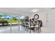 Bright dining room with modern glass table and neutral chairs, plus sliding glass doors to outside view at 49 Interlaken Rd, Orlando, FL 32804