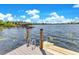 Lakefront dock with ladder, offering easy access to the water for swimming and boating at 49 Interlaken Rd, Orlando, FL 32804