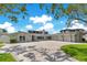 Stunning home with a spacious paver driveway, manicured lawn, and three-car garage at 49 Interlaken Rd, Orlando, FL 32804