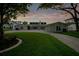 Lovely home exterior at dusk exhibiting a manicured lawn, elegant landscaping, and soft outdoor lighting, creating an inviting ambiance at 49 Interlaken Rd, Orlando, FL 32804