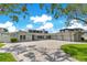 Beautiful home exterior featuring a large driveway, well-manicured lawn, and three-car garage at 49 Interlaken Rd, Orlando, FL 32804