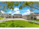 Stunning exterior view with a large driveway and well-maintained landscaping at 49 Interlaken Rd, Orlando, FL 32804