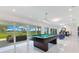 Spacious game room includes a pool table and scenic views of the backyard with sliding glass doors and patio access at 49 Interlaken Rd, Orlando, FL 32804