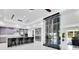 Bright kitchen with a wine rack, island seating, stainless appliances, gray cabinets, and modern finishes at 49 Interlaken Rd, Orlando, FL 32804