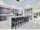 Modern kitchen featuring a large island with seating and sleek grey cabinetry at 49 Interlaken Rd, Orlando, FL 32804