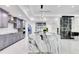Modern kitchen with a large island, gray cabinets, and a glass-enclosed wine storage area at 49 Interlaken Rd, Orlando, FL 32804