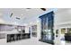 Bright modern kitchen features a wine rack, stainless steel appliances, and gray cabinetry with a central island at 49 Interlaken Rd, Orlando, FL 32804