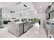 Spacious kitchen featuring a marble island, stainless steel appliances, and views of the living area at 49 Interlaken Rd, Orlando, FL 32804