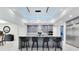 Spacious kitchen island with bar stools, modern lighting, and sleek gray cabinets at 49 Interlaken Rd, Orlando, FL 32804