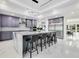 Modern kitchen with a large island, gray cabinets, stainless steel appliances, and barstool seating at 49 Interlaken Rd, Orlando, FL 32804