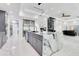 Spacious kitchen featuring a marble island, stainless steel appliances, and a glass wine cellar at 49 Interlaken Rd, Orlando, FL 32804