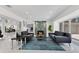 Bright living room with a unique fireplace, modern furniture, and access to other rooms at 49 Interlaken Rd, Orlando, FL 32804
