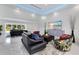 Modern living room featuring marble floors, blue LED lighting, and ample natural light at 49 Interlaken Rd, Orlando, FL 32804