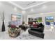 Living room with colorful seating and television, offering a cozy and modern ambiance at 49 Interlaken Rd, Orlando, FL 32804