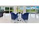Cozy sitting area with stylish blue chairs, sliding glass doors that offers views of the yard, and lots of natural light at 49 Interlaken Rd, Orlando, FL 32804