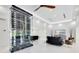 Open living room features sleek furniture, a modern wine rack, and a view of the outdoor space at 49 Interlaken Rd, Orlando, FL 32804