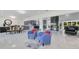 Bright living space with chairs, dining table, kitchen, and a view of the wine rack at 49 Interlaken Rd, Orlando, FL 32804