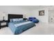 Main bedroom featuring marble floors, a blue bed set, and a comfortable blue chaise lounge at 49 Interlaken Rd, Orlando, FL 32804