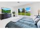 Main bedroom featuring marble floors, backyard water views, and a TV at 49 Interlaken Rd, Orlando, FL 32804