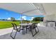 Inviting outdoor patio with a dining set, overlooking a serene landscape and a built in grill, perfect for relaxation and entertainment at 49 Interlaken Rd, Orlando, FL 32804