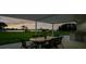 Covered outdoor patio with dining table and grill perfect for enjoying outdoor meals at 49 Interlaken Rd, Orlando, FL 32804