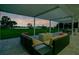 Covered outdoor patio with water view and seating is perfect for entertaining and enjoying the sunset at 49 Interlaken Rd, Orlando, FL 32804