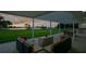 Covered patio seating area offers serene backyard views at 49 Interlaken Rd, Orlando, FL 32804