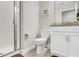 Clean bathroom with white fixtures, a glass-enclosed shower, and modern finishes at 4984 Windermere Ave, Kissimmee, FL 34746