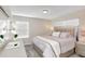 Serene bedroom with a comfy bed, soft neutral tones, side tables, and lots of natural light from the window at 4984 Windermere Ave, Kissimmee, FL 34746