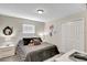 Fun bedroom features a cozy bed with Disney decor, a large window, white furniture, and ample closet space at 4984 Windermere Ave, Kissimmee, FL 34746