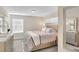 Serene bedroom with neutral tones, a comfortable bed, and plenty of natural light at 4984 Windermere Ave, Kissimmee, FL 34746