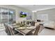 Modern dining room featuring a table set for eight, with bright, neutral decor and open floor plan at 4984 Windermere Ave, Kissimmee, FL 34746