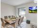 Stylish dining room showcasing a modern table set for eight and bright, natural lighting at 4984 Windermere Ave, Kissimmee, FL 34746