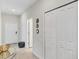 Bright hallway featuring a white door, storage closet, modern decor, and neutral-toned walls at 4984 Windermere Ave, Kissimmee, FL 34746