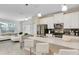 Bright open-concept kitchen with stainless steel appliances and a spacious island with breakfast bar seating at 4984 Windermere Ave, Kissimmee, FL 34746