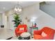 Cozy living room featuring vibrant orange chairs, unique lighting, and stylish decor at 4984 Windermere Ave, Kissimmee, FL 34746