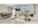 Bright living room features modern furnishings, large windows, and a seamless transition to the dining area with dining table at 4984 Windermere Ave, Kissimmee, FL 34746