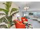 Stylish living room featuring bright orange accent chairs, modern lighting, and an open layout at 4984 Windermere Ave, Kissimmee, FL 34746