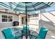 Outdoor pool area featuring covered table with four chairs for shaded relaxation at 4984 Windermere Ave, Kissimmee, FL 34746