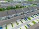 Aerial view of townhomes with garages, driveways, and well-maintained landscaping in a neatly organized community at 5029 Walker St, St Cloud, FL 34771