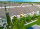 Aerial view of residential townhomes showing lush landscaping, and a well-maintained neighborhood at 5029 Walker St, St Cloud, FL 34771