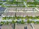 Aerial view of townhomes in a community with landscaped streets and organized parking in a well-maintained neighborhood at 5029 Walker St, St Cloud, FL 34771