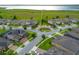 Aerial view of a residential community with tree-lined streets, sidewalks, and roundabout with beautifully landscaped lawns at 5029 Walker St, St Cloud, FL 34771