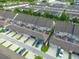 Aerial view showcases community townhomes with garages and well-kept exteriors in a suburban setting at 5029 Walker St, St Cloud, FL 34771